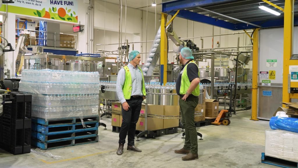 xpak staff member and eastcoast staff member in factory working