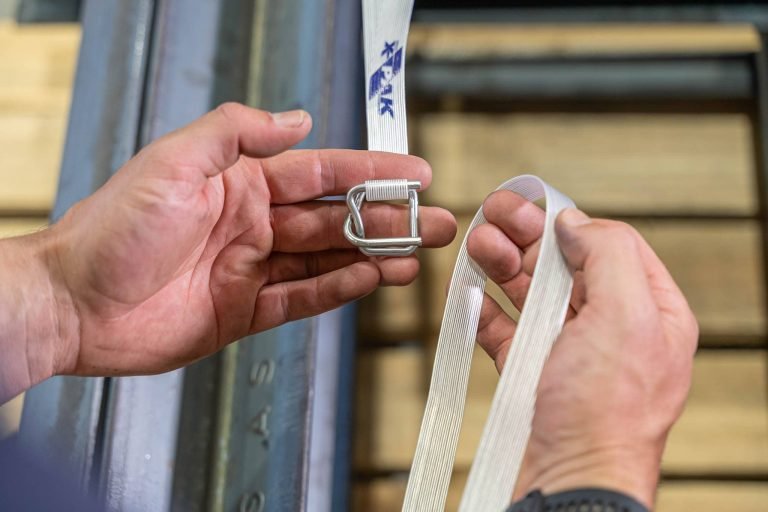 person holding composite strapping and buckle